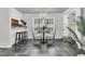 A bright dining area with a chandelier and seating for two, next to a kitchen bar area at 615 Fairington Dr, Summerville, SC 29485