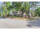 Stunning brick house features a charming balcony and a two-car garage, surrounded by lush green trees at 615 Fairington Dr, Summerville, SC 29485
