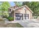 Side exterior view of a brick home with an attached two-car garage and beautifully landscaped front at 615 Fairington Dr, Summerville, SC 29485
