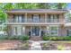 Charming brick home featuring a lovely front yard, covered porch and beautiful second-story balcony at 615 Fairington Dr, Summerville, SC 29485