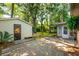 An outdoor brick patio near a small shed with a well-maintained green lawn and surrounding trees at 620 Clearview Dr, Charleston, SC 29412