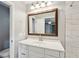 Bathroom vanity featuring white cabinets, an undermount sink, a wood framed mirror and stylish lighting at 620 Clearview Dr, Charleston, SC 29412