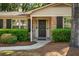 Close-up of the front door with brick facade and neatly trimmed hedges at 620 Clearview Dr, Charleston, SC 29412