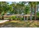 Charming single-story home with manicured lawn, mature trees and classic brick accents at 620 Clearview Dr, Charleston, SC 29412