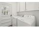 Laundry room with washer, dryer, cabinets, and tile floors at 620 Clearview Dr, Charleston, SC 29412