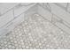 Shower floor featuring small, decorative honeycomb tiles and white subway tile at 620 Clearview Dr, Charleston, SC 29412