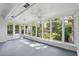 Bright sunroom with multiple windows and a ceiling fan overlooking lush greenery at 620 Clearview Dr, Charleston, SC 29412