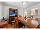 Bright dining room featuring an expansive table, elegant decor, and an adjacent pass-through window at 675 Fair Spring Dr, Charleston, SC 29414