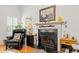 Elegant fireplace with black marble hearth, complemented by a cozy chair and stylish decor creates a warm ambiance at 675 Fair Spring Dr, Charleston, SC 29414