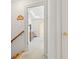 Hallway view featuring hardwood stairs, leading to carpeted floor, a dresser, and neutral wall paint at 675 Fair Spring Dr, Charleston, SC 29414