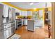 Spacious kitchen featuring stainless steel appliances, white cabinetry, and hardwood floors at 675 Fair Spring Dr, Charleston, SC 29414