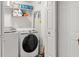 Well-organized laundry room with washer, dryer, shelving, and cleaning supplies at 675 Fair Spring Dr, Charleston, SC 29414