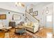 Comfortable living room with hardwood floors, cozy seating, and staircase, offering a welcoming atmosphere for relaxation at 675 Fair Spring Dr, Charleston, SC 29414