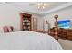 Bright main bedroom featuring a wooden bed frame, dresser, and bookcase at 675 Fair Spring Dr, Charleston, SC 29414