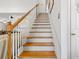 Classic staircase with wood railings and white risers leading to the upper level at 675 Fair Spring Dr, Charleston, SC 29414