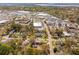 Aerial view displaying a mix of residential homes and commercial buildings with abundant parking amidst lush greenery at 706 White Oak Dr, Charleston, SC 29407