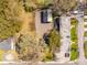 Birds-eye view of property showcasing building roofs, gravel area, mature trees and some vehicle parking at 706 White Oak Dr, Charleston, SC 29407