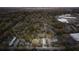 An aerial view of a neighborhood showing tree coverage, housing density, and proximity to a commercial area at 706 White Oak Dr, Charleston, SC 29407