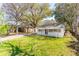 Aerial view showcasing a charming single-story home with a lush green lawn and mature trees at 706 White Oak Dr, Charleston, SC 29407
