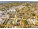 Aerial view featuring residential homes intermixed with commercial areas and parking, surrounded by lush trees at 706 White Oak Dr, Charleston, SC 29407