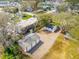 An aerial view of a residential property, featuring a detached garage, a well-kept lawn, and mature trees at 706 White Oak Dr, Charleston, SC 29407