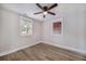 Bright bedroom with two windows, wood-look flooring and a modern ceiling fan at 706 White Oak Dr, Charleston, SC 29407