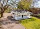 Charming single-story home with a covered front porch, mature tree, and a gravel driveway at 706 White Oak Dr, Charleston, SC 29407