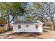 Backyard exterior featuring mature trees and tidy landscaping at 706 White Oak Dr, Charleston, SC 29407