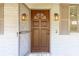 A close-up of the detailed wood front door with ornate hardware and lighting at 706 White Oak Dr, Charleston, SC 29407