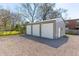 Three-car garage featuring durable metal construction, ample space, and a convenient side door at 706 White Oak Dr, Charleston, SC 29407