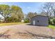 Side view of garage with a white entry door and gravel lot at 706 White Oak Dr, Charleston, SC 29407