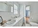 Bathroom features double sinks, and classic tile, with a door leading to the bedroom at 710 S Magnolia St, Summerville, SC 29483