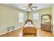 Cozy bedroom with hardwood floors, ceiling fan, and a vintage-style furniture set at 710 S Magnolia St, Summerville, SC 29483