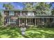 Traditional brick home with lush lawn, manicured landscaping, and welcoming front porch at 710 S Magnolia St, Summerville, SC 29483