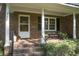 Charming brick home entrance with brick steps, quaint bench, and lovely plants at 710 S Magnolia St, Summerville, SC 29483