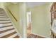Inviting hallway with hardwood floors, staircase, and view into adjacent room at 710 S Magnolia St, Summerville, SC 29483