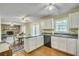 Open kitchen with breakfast bar, and view into the living room with fireplace at 710 S Magnolia St, Summerville, SC 29483