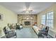 Relaxing living room with brick fireplace, ceiling fan, and comfortable seating at 710 S Magnolia St, Summerville, SC 29483