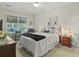 Cozy bedroom with a bed, ceiling fan, and large window for natural light at 7101 Bowen Corner Ave, Hanahan, SC 29410