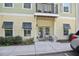 Inviting condo entrance featuring a balcony, double glass doors and chairs on the front porch at 7101 Bowen Corner Ave, Hanahan, SC 29410