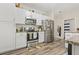 Well-lit kitchen featuring stainless steel appliances, granite countertops, and light wood flooring at 7101 Bowen Corner Ave, Hanahan, SC 29410