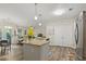 Open concept kitchen with a granite island, modern appliances, and hardwood floors at 7101 Bowen Corner Ave, Hanahan, SC 29410