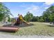 Community playground with wooden playset, bench, and mature trees at 7101 Bowen Corner Ave, Hanahan, SC 29410