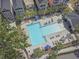 Aerial view of a large swimming pool with palm trees and lounge chairs at 7101 Bowen Corner Ave, Hanahan, SC 29410