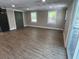Spacious living room featuring neutral paint, windows, and wood look floors at 78 Hannibal Trl, Ridgeville, SC 29472