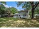 Scenic backyard view showcases a lush lawn and the house with mature trees at 7993 Malden Ave, North Charleston, SC 29420