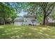 Backyard featuring a lush green lawn and the rear of the white brick house at 7993 Malden Ave, North Charleston, SC 29420