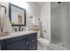 Bathroom features a dark vanity, granite countertops, and a glass enclosed shower at 7993 Malden Ave, North Charleston, SC 29420