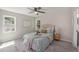 Bright bedroom with ceiling fan, a decorative rug and two windows for natural light at 7993 Malden Ave, North Charleston, SC 29420