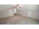 Large bedroom with light wood flooring, ceiling fan, and stairs at 7993 Malden Ave, North Charleston, SC 29420